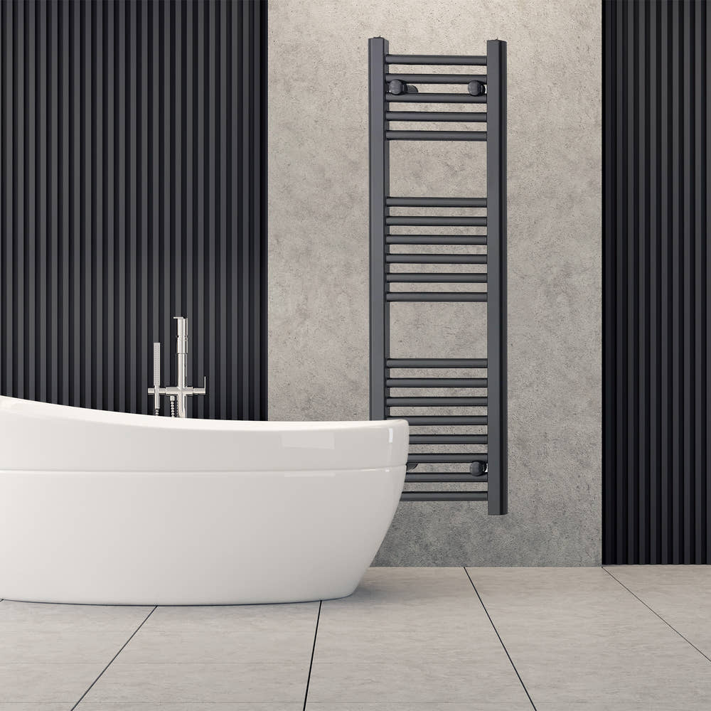 Black towel radiator beside a freestanding bath
