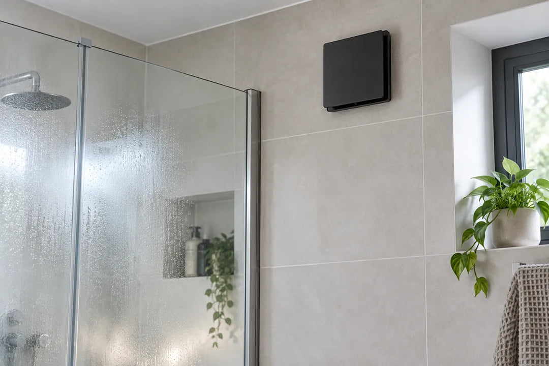 Illustration of a matte black extractor fan above misted shower glass in a tiled bathroom.