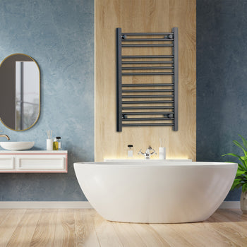 Matt black heated towel rail radiator mounted in a bathroom