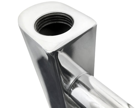 Close-up of a chrome towel radiator rail and pipe connection.