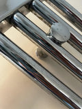 Close-up of a chrome towel radiator surface and joint